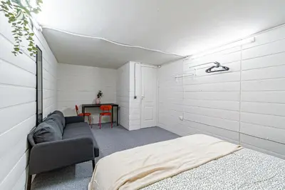 a bedroom with a bed and a table with a chair at STAY Kaunas city center in Kaunas