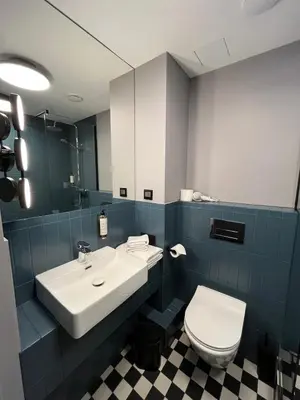 a bathroom with a white sink and a toilet at Modern Room in Central Vilnius in Vilnius