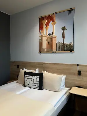 a bedroom with a bed with a mirror on the wall at Modern Room in Central Vilnius in Vilnius