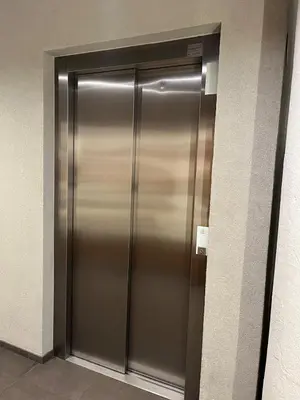 a stainless steel elevator door in a building at Modern Room in Central Vilnius in Vilnius