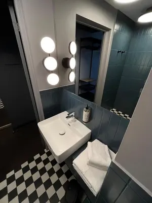 a bathroom with a sink and a mirror at Modern Room in Central Vilnius in Vilnius