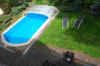 an overhead view of a swimming pool with two chairs at Ramuma in Vilnius