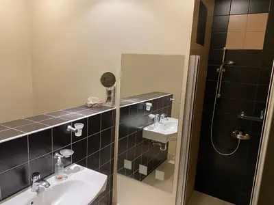 a bathroom with two sinks and a shower at Ramuma in Vilnius