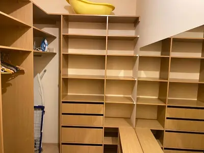 a walk in closet with wooden shelves at Ramuma in Vilnius