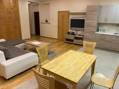 a living room with a table and a couch at Ramuma in Vilnius