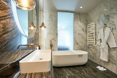 a bathroom with a white sink and a mirror at Old Town Pearl Suite in Kaunas