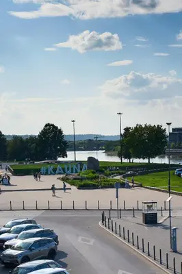 a parking lot filled with parked cars in a parking lot at Old Town Pearl Suite in Kaunas