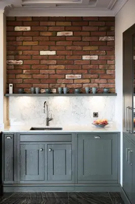 a kitchen with a sink and a brick wall at Old Town Pearl Suite in Kaunas