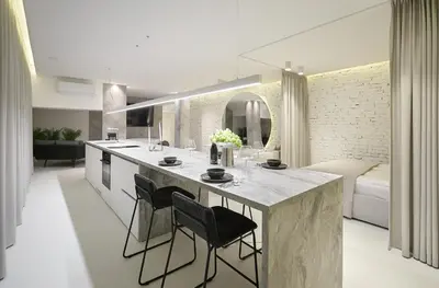a kitchen and living room with a large island with chairs at Provokatas in Kaunas