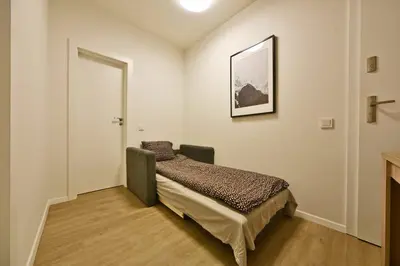 a bedroom with a bed and a picture on the wall at Domillion 2bdr 2bath on Vokieciu w parking V1020A in Vilnius