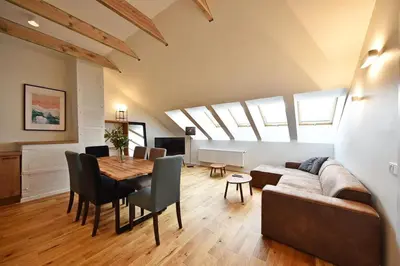a living room with a couch and a table with chairs at Domillion Penthouse 2bdr 2bath P364a in Vilnius