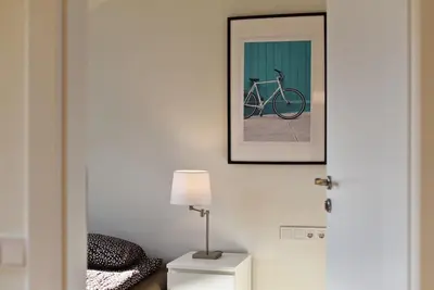 a picture of a bike on a wall with a lamp at Domillion Penthouse 2bdr 2bath P364a in Vilnius