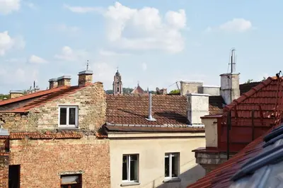 a view of roofs of buildings with a clock tower at Domillion Penthouse 2bdr 2bath P364a in Vilnius