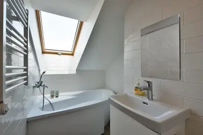 a white bathroom with a sink and a bath tub at Domillion Penthouse 2bdr 2bath P364a in Vilnius