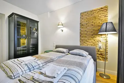 a bedroom with a bed with towels on it at Domillion 2bdr President Palace free parking L417 in Vilnius