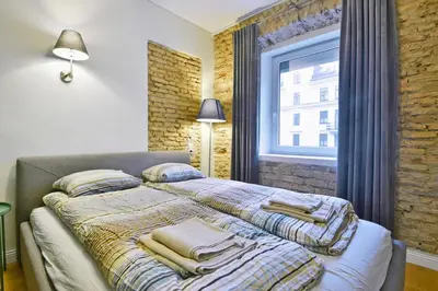 a bedroom with a bed with blankets and a window at Domillion 2bdr President Palace free parking L417 in Vilnius