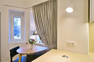 a small room with a table and a window at Domillion 2bdr President Palace free parking L417 in Vilnius