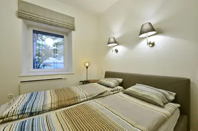 a bedroom with two beds and a window at Domillion 3bdr 2baths President Palace park L419A in Vilnius