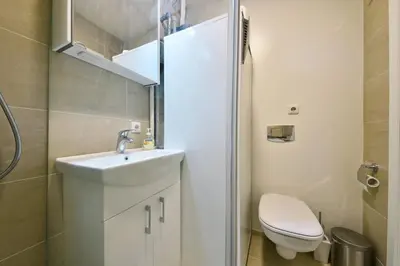 a small bathroom with a sink and a toilet at Domillion 3bdr 2baths President Palace park L419A in Vilnius