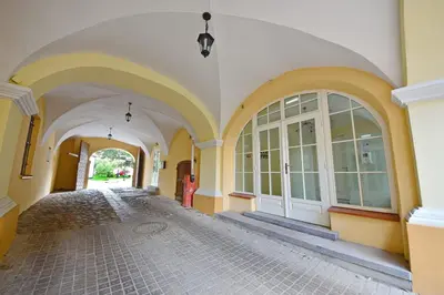 an empty hallway of a building with white and yellow walls at Domillion New modern Vilnius old town studio U2302 in Vilnius