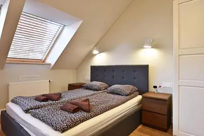 a bedroom with a large bed with pillows on it at Domillion New modern Vilnius old town studio U2302 in Vilnius