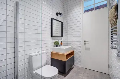 a white bathroom with a toilet and a sink at Domillion New modern Vilnius old town studio U2304 in Vilnius