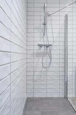 a shower with a shower head in a bathroom at Domillion New modern Vilnius old town studio U2304 in Vilnius
