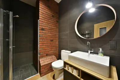 a bathroom with a white sink and a mirror at Domillion 1bdr New old town apt U2305 in Vilnius
