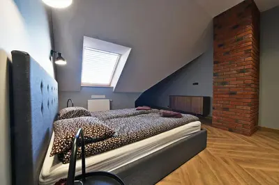 a bedroom with a large bed in a attic at Domillion 1bdr New old town apt U2305 in Vilnius