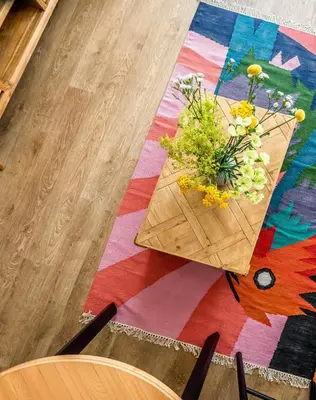 a table with a vase of flowers on it at Domillion 2bdr New Scandinavian old town apt N2A5 in Vilnius