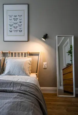 a bedroom with a bed with a mirror next to it at Domillion 2bdr New Scandinavian old town apt N2A5 in Vilnius