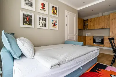 a bedroom with a large bed and some pictures on the wall at Domillion 2bdr New Scandinavian old town apt N2A5 in Vilnius