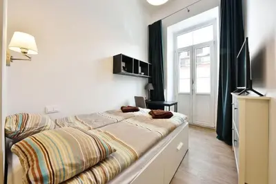 a bedroom with a bed and a television in it at Domillion Duplex Apt 11 ppl 4baths Vokieciu V10C in Vilnius