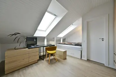a bedroom with a desk and a bed with a window at Domillion Duplex Apt 11 ppl 4baths Vokieciu V10C in Vilnius