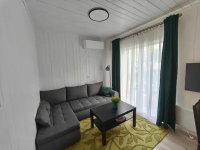 a living room with a couch and a table at Gervių takas 2