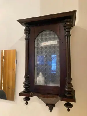 a wooden clock on a wall with a window at Paupio krantas in Vilnius