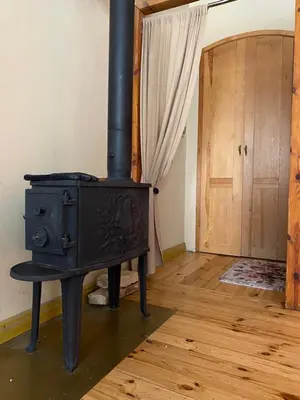 a black stove in a room with a door at Paupio krantas in Vilnius