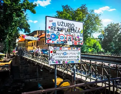 a street sign in front of a bridge at Paupio krantas in Vilnius