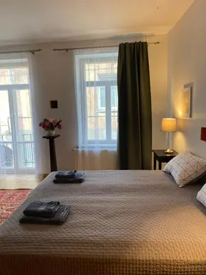 a bedroom with a bed with two towels on it at Paupio krantas in Vilnius
