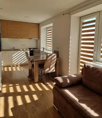 a living room with a table and a couch at Vytautas central apartament in Kaunas
