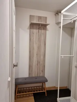 a room with a bench and a wooden wall at Vytautas central apartament in Kaunas
