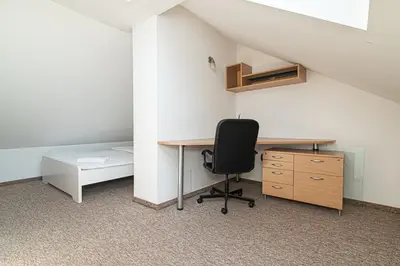 an office with a desk and a bed and a chair at Spacious 3 BDR apartment in Old Town in Vilnius