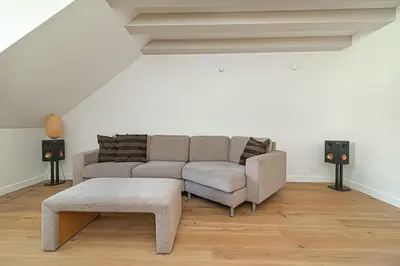 a living room with a couch and a table at Spacious 3 BDR apartment in Old Town in Vilnius