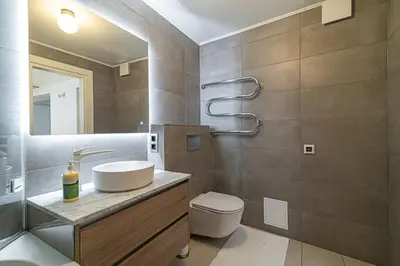 a bathroom with a sink and a toilet at Spacious 3 BDR apartment in Old Town in Vilnius