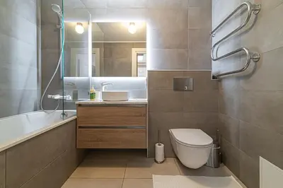 a bathroom with a toilet and a sink and a tub at Spacious 3 BDR apartment in Old Town in Vilnius