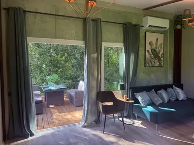 a living room with a couch and a table at Forest Resort House
