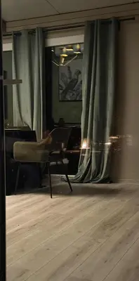 a living room with a chair and a window at Forest Resort House