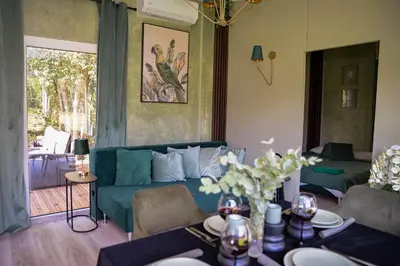 a living room with a couch and a table at Forest Resort House