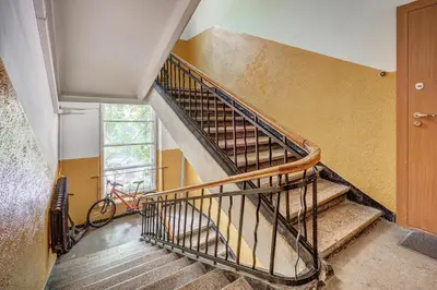 a staircase in a house with a bike in a room at Elegant 2-Bedroom in city center in Vilnius