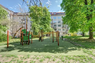 a playground in a park in front of a building at Elegant 2-Bedroom in city center in Vilnius